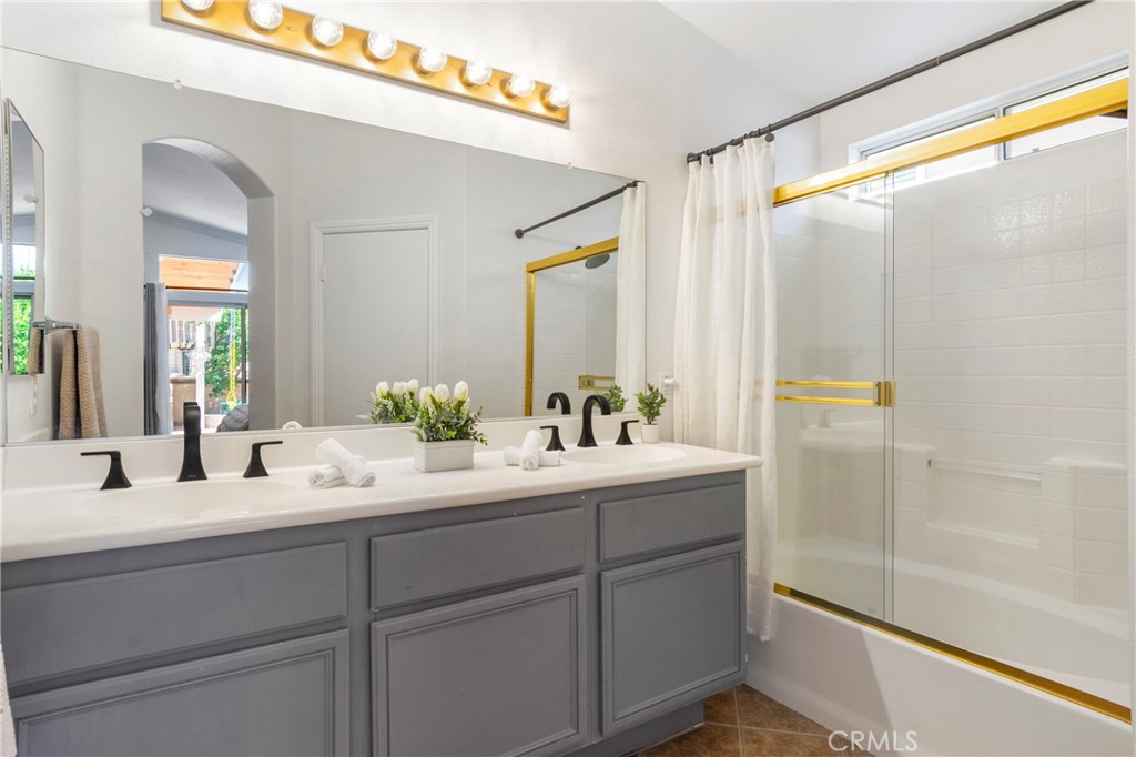 16366 West Sun Canyon Street Riverside, CA 92503 - Photo 13 of 21 a bathroom with a double vanity sink and mirror