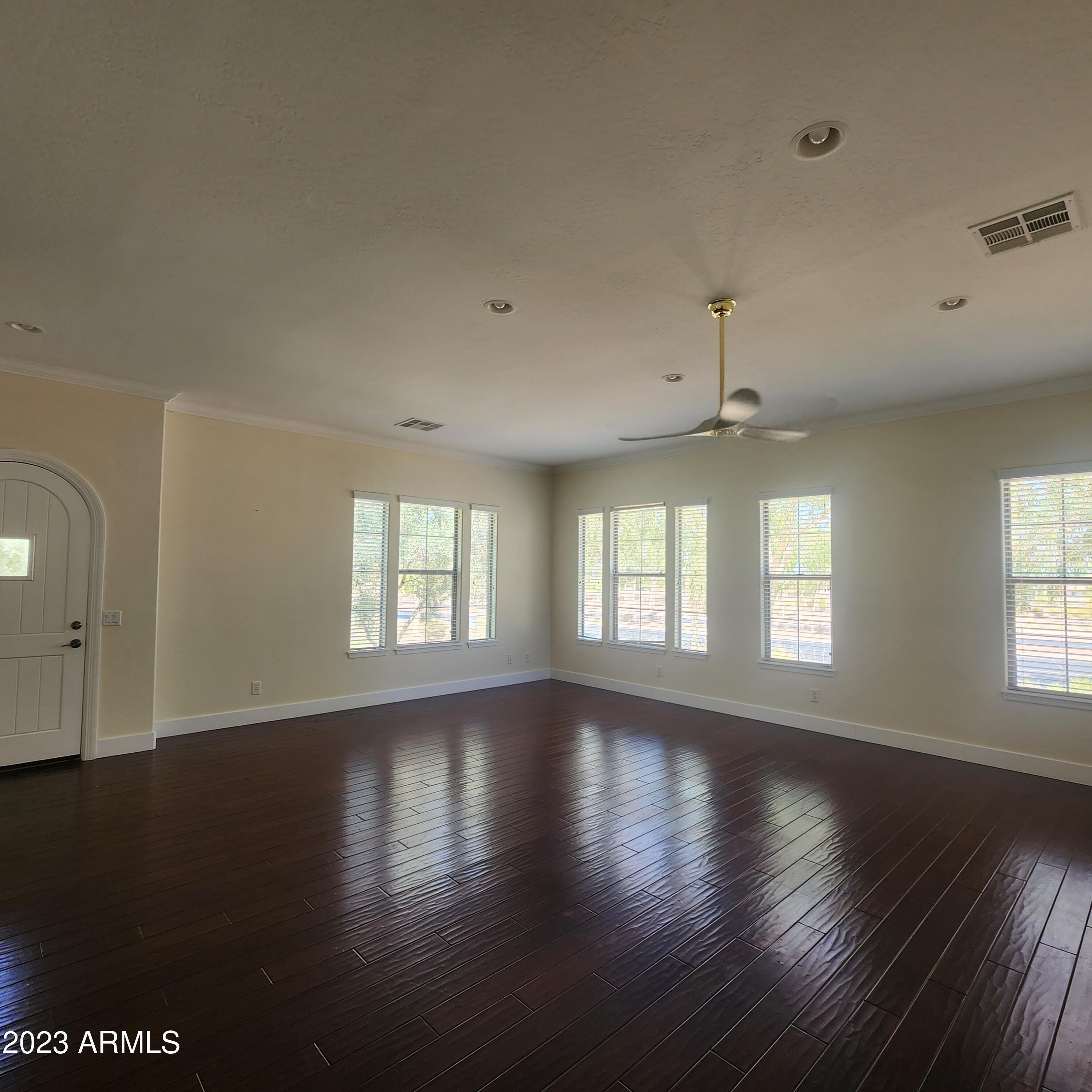 4553 North Point Ridge Road Buckeye, AZ 85396 - Photo 7 of 13 a view of an empty room with wooden floor and a window