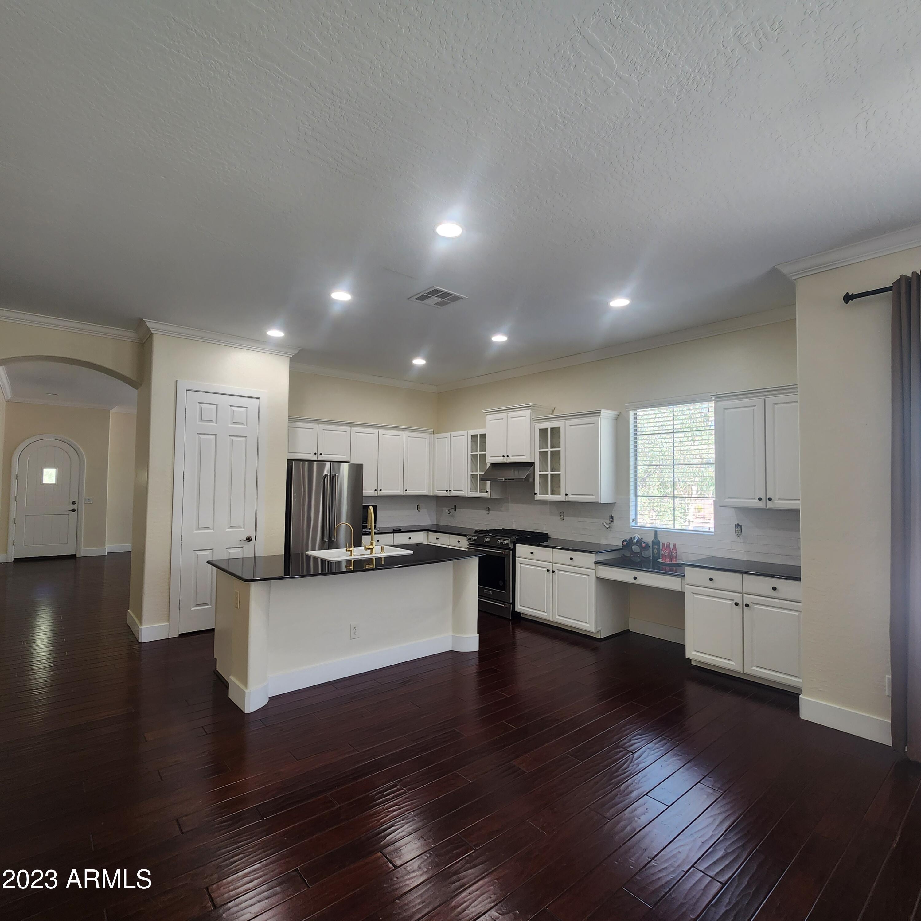 4553 North Point Ridge Road Buckeye, AZ 85396 - Photo 8 of 13 a kitchen with a sink and wooden floor