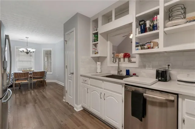 a kitchen with a sink cabinets and wooden floor
