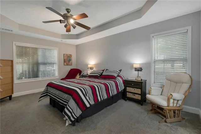 a bed room with a bed and a chair