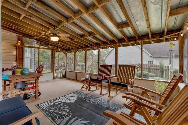 a living room with furniture a wooden floor and next to a window