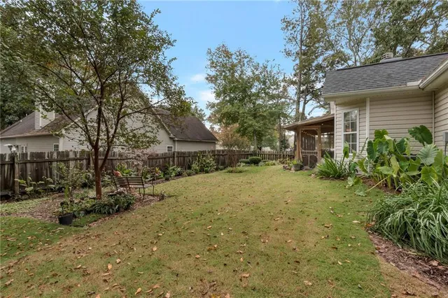 a view of backyard of house with green space