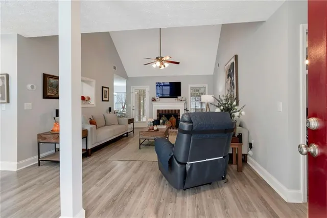 a living room with furniture a fireplace and a chandelier