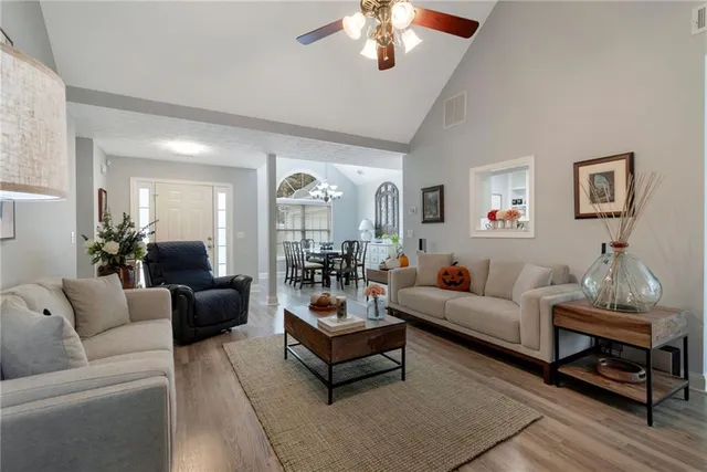 a living room with furniture and a chandelier