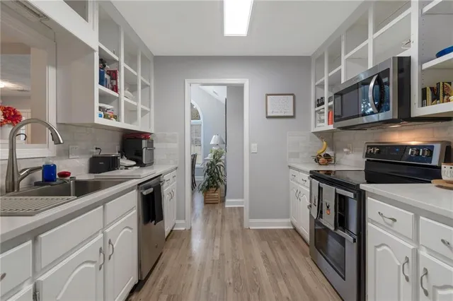 a kitchen with stainless steel appliances granite countertop a stove and cabinets
