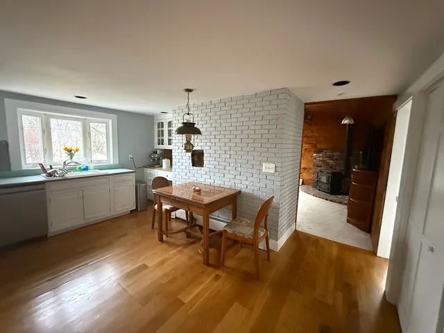 a view of a dining room with furniture and window