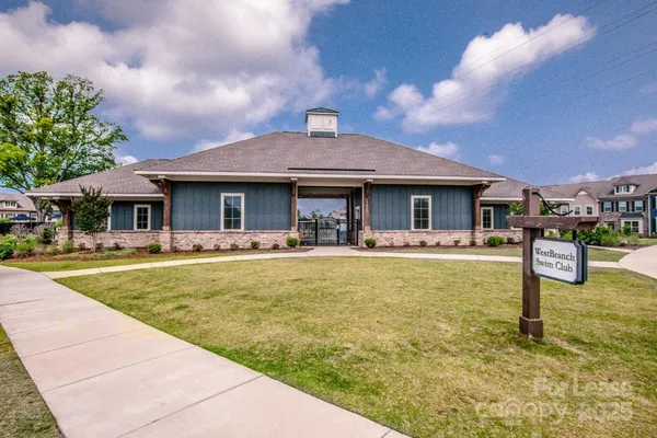 a front view of a house with swimming pool and porch