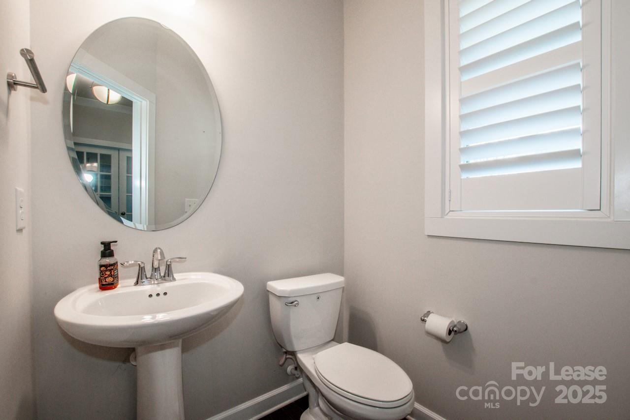 13218 Caite Ridge Road Davidson, NC 28036 - Photo 28 of 48 a bathroom with a toilet sink and mirror