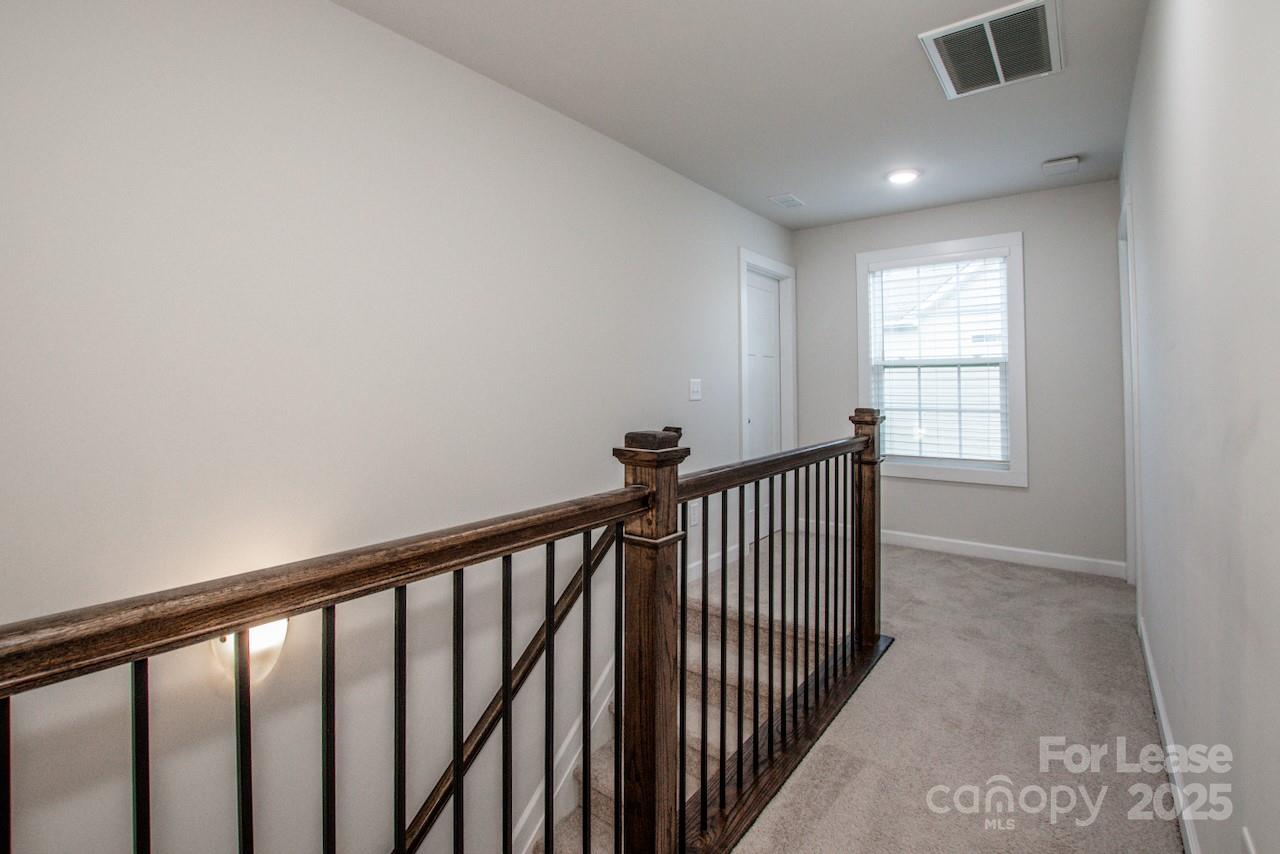 13218 Caite Ridge Road Davidson, NC 28036 - Photo 30 of 48 a view of a hallway with window