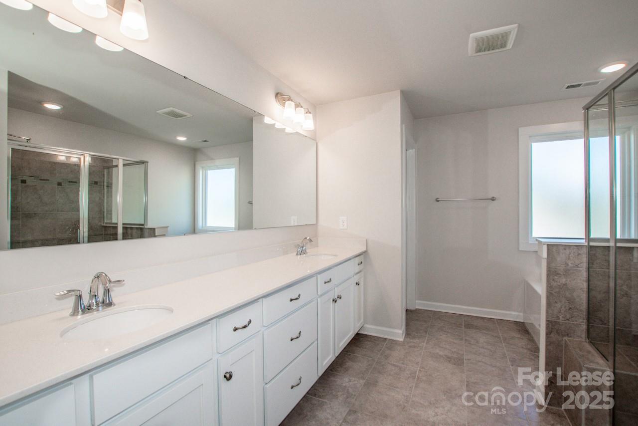 13218 Caite Ridge Road Davidson, NC 28036 - Photo 42 of 48 a bathroom with a double vanity sink and a mirror