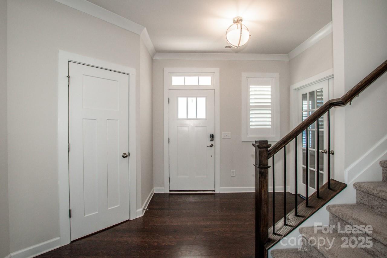13218 Caite Ridge Road Davidson, NC 28036 - Photo 9 of 48 a view of a hallway with wooden floor and staircase