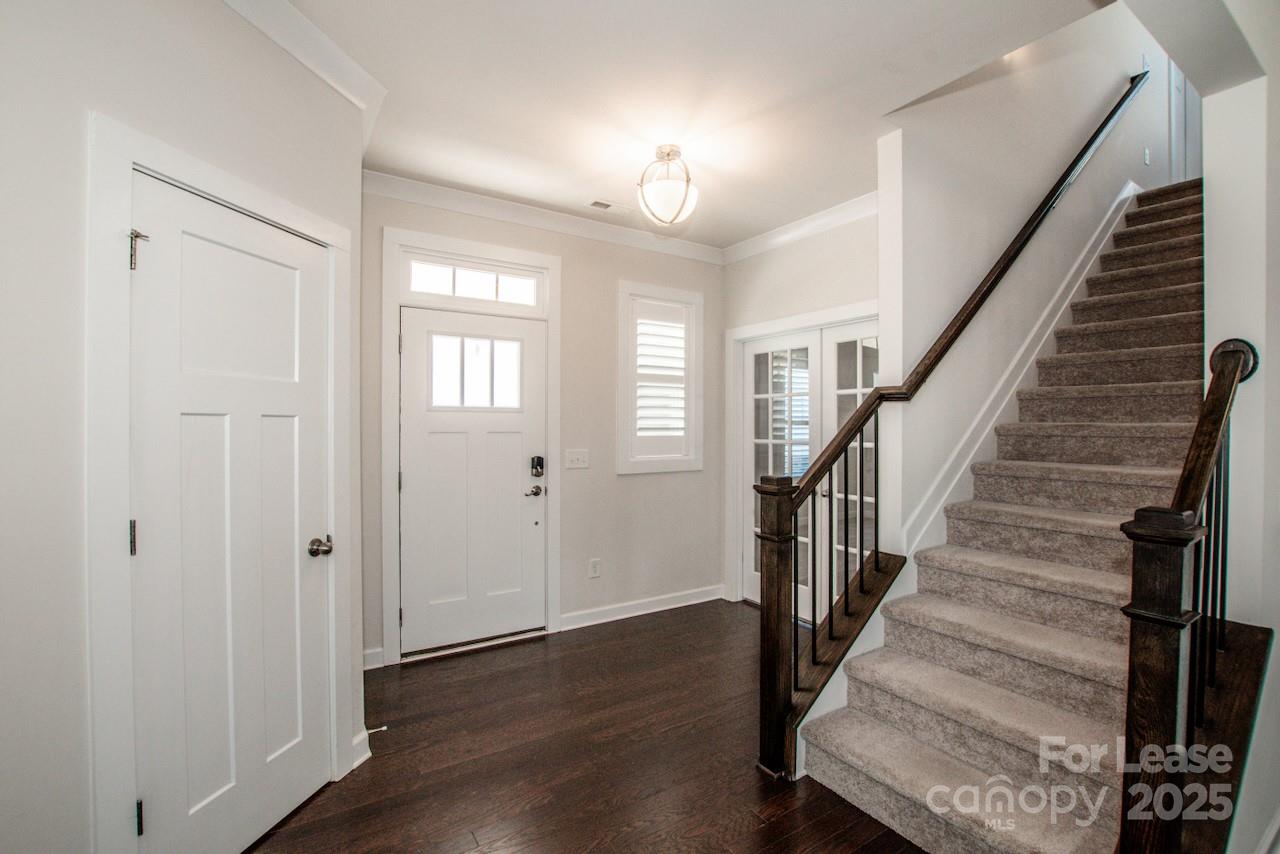 13218 Caite Ridge Road Davidson, NC 28036 - Photo 10 of 48 a view of a hallway with wooden floor and staircase