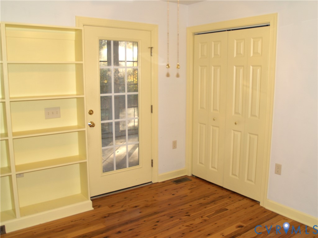 3129 Chickahominy Road Toano, VA 23168 - Photo 12 of 39 a view of an empty room with wooden floor and a window
