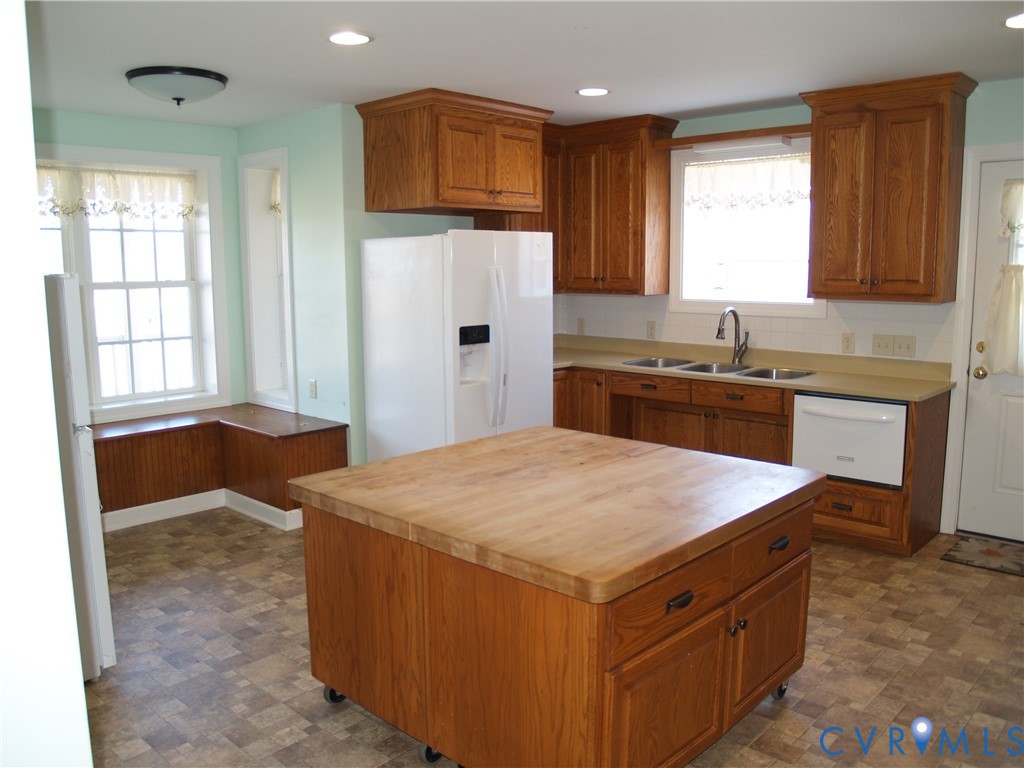 3129 Chickahominy Road Toano, VA 23168 - Photo 15 of 39 a kitchen with a stove a sink a refrigerator and cabinets