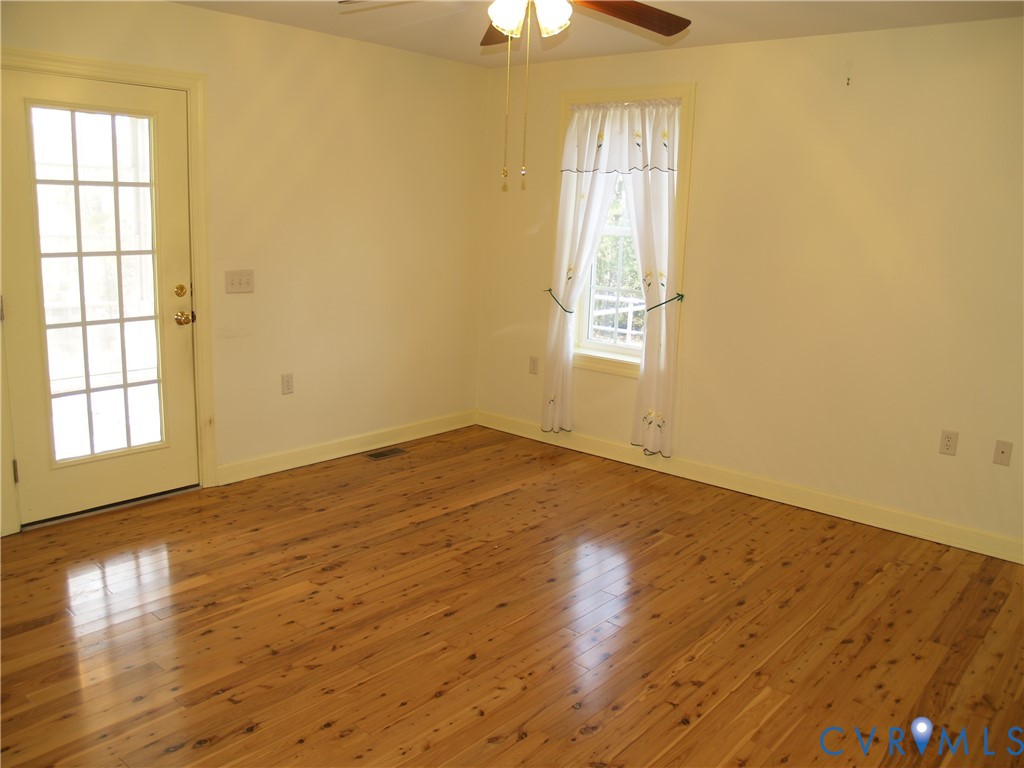 3129 Chickahominy Road Toano, VA 23168 - Photo 9 of 39 a view of empty room with wooden floor and fan