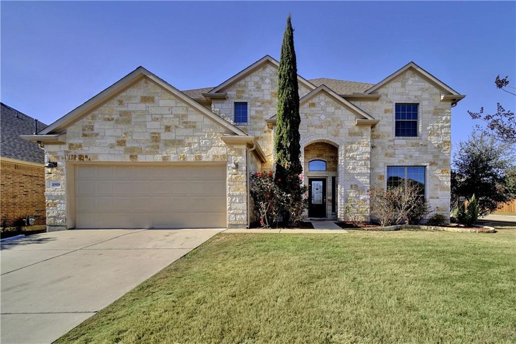 a front view of a house with garage