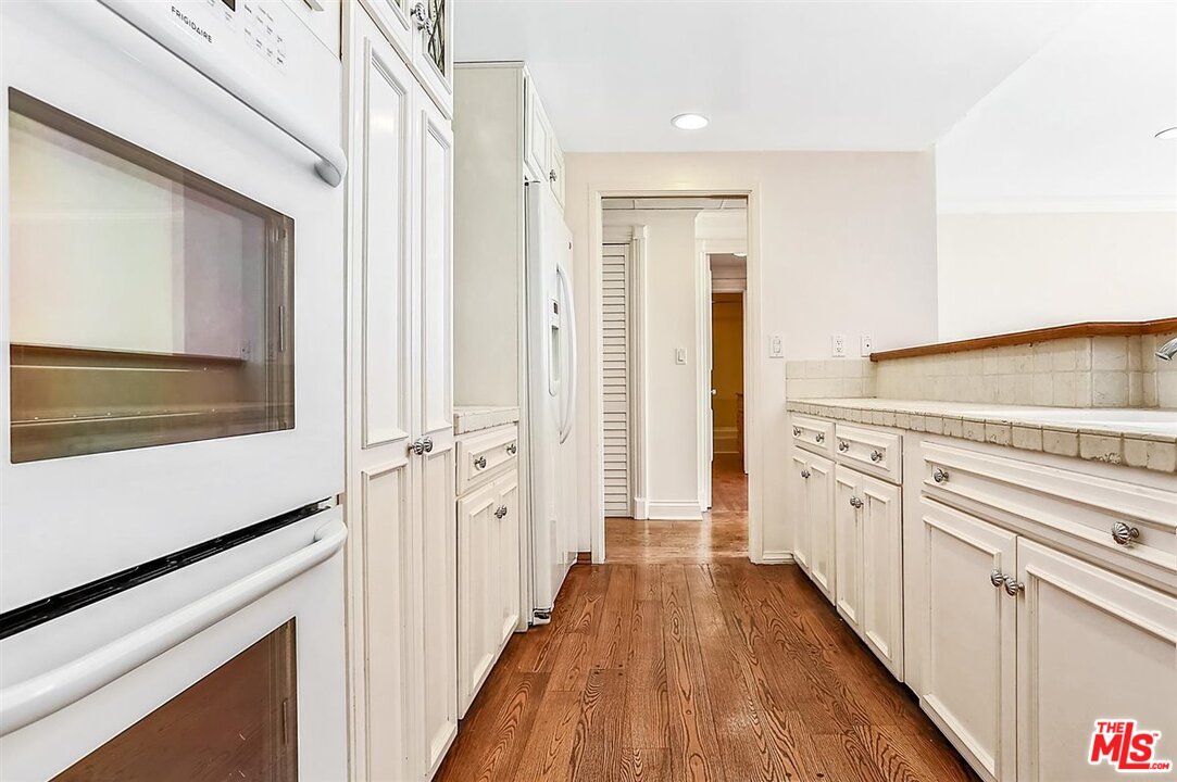 2160 Century Park East, Unit 1903 Los Angeles, CA 90067 - Photo 12 of 40 a view of a kitchen with a sink and refrigerator