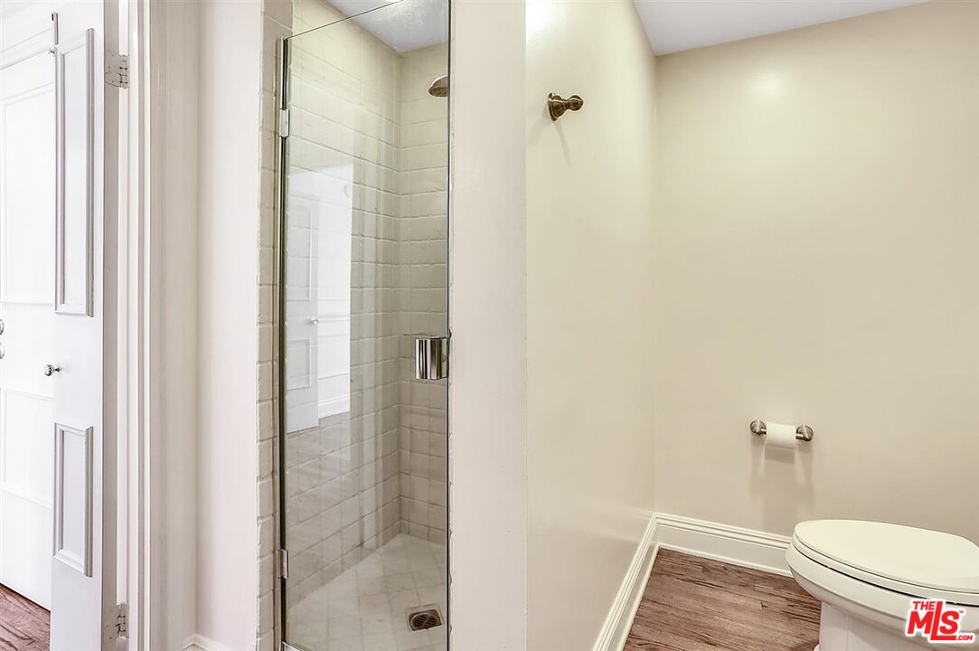 2160 Century Park East, Unit 1903 Los Angeles, CA 90067 - Photo 18 of 40 a bathroom with a granite countertop shower and a toilet