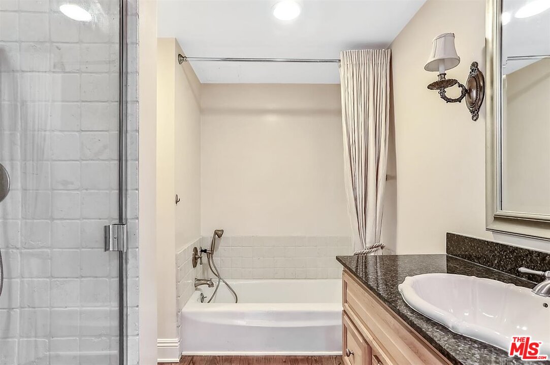 2160 Century Park East, Unit 1903 Los Angeles, CA 90067 - Photo 20 of 40 a bathroom with a granite countertop sink and a bathtub