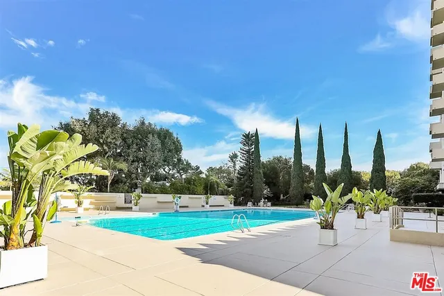 a view of a swimming pool with a yard