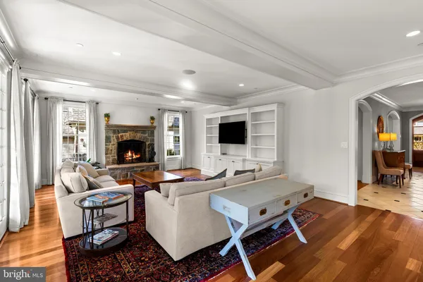 a living room with furniture flat screen tv and a fireplace