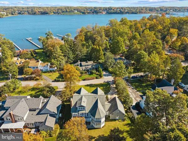 an aerial view of a residential houses with outdoor space and swimming pool