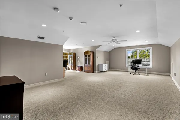 a living room with a fireplace and a floor to ceiling window