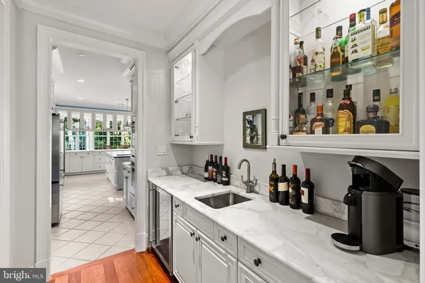 a kitchen with granite countertop a sink and white cabinets