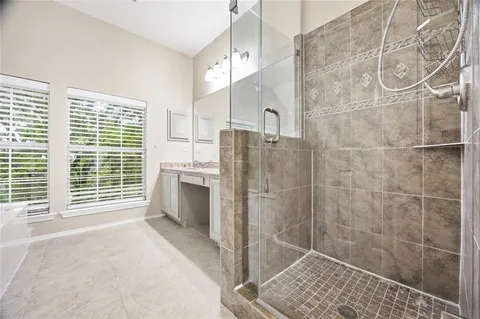 a bathroom with a granite countertop sink a bathtub and shower