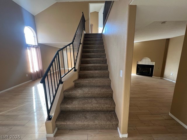 4140 North Compass Rose Way Las Vegas, NV 89108 - Photo 4 of 16 Stairs with wood finish floors and a fireplace
