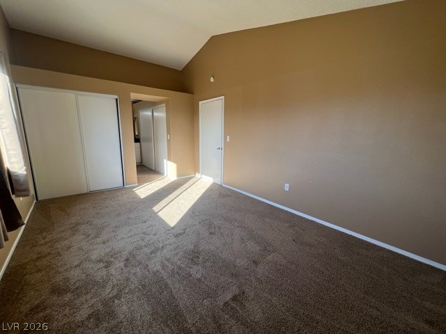 4140 North Compass Rose Way Las Vegas, NV 89108 - Photo 9 of 16 Unfurnished bedroom with a closet, carpet flooring, vaulted ceiling, and ensuite bath