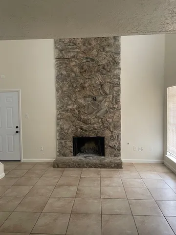 a view of empty room with a fireplace