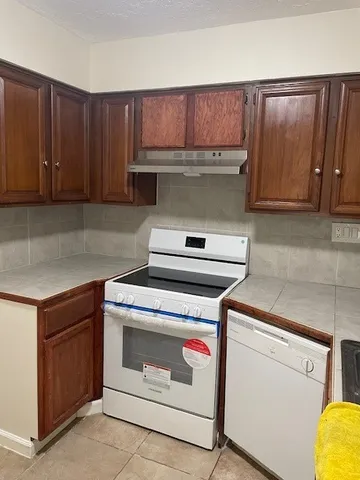 a kitchen with a stove and a cabinet
