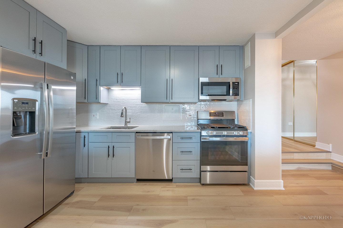 8801 West Golf Road, Unit 2I Niles, IL 60714 - Photo 12 of 29 a kitchen with stainless steel appliances granite countertop a stove a refrigerator and a sink