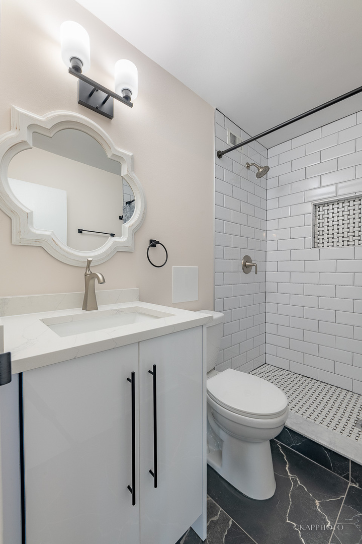 8801 West Golf Road, Unit 2I Niles, IL 60714 - Photo 21 of 29 a bathroom with a sink toilet and shower