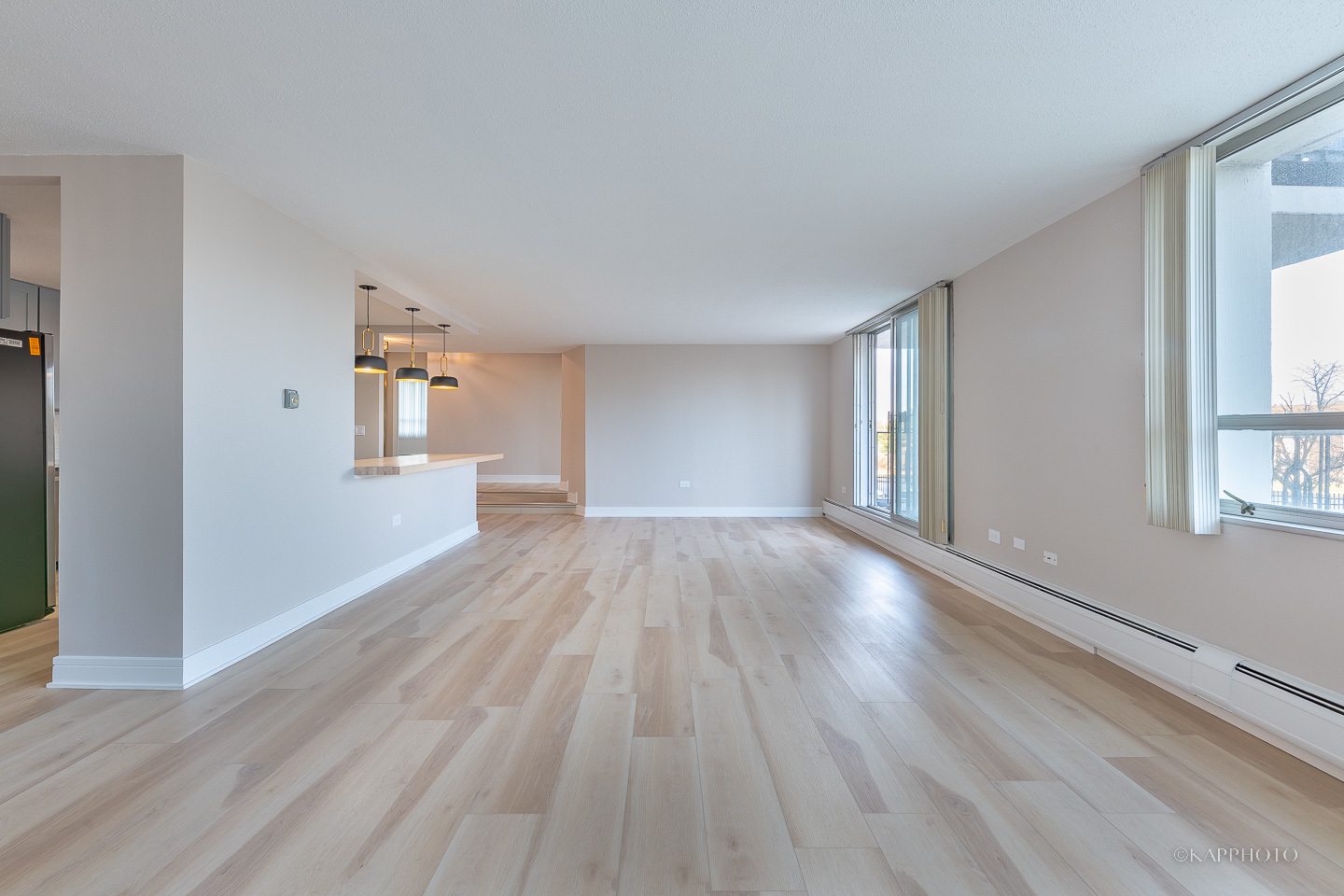 8801 West Golf Road, Unit 2I Niles, IL 60714 - Photo 7 of 29 a view of empty room with wooden floor and fan