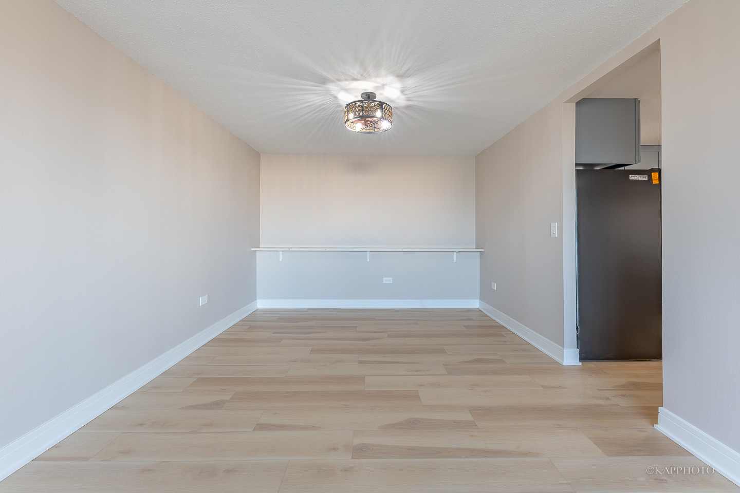 8801 West Golf Road, Unit 2I Niles, IL 60714 - Photo 8 of 29 a view of an empty room with wooden floor