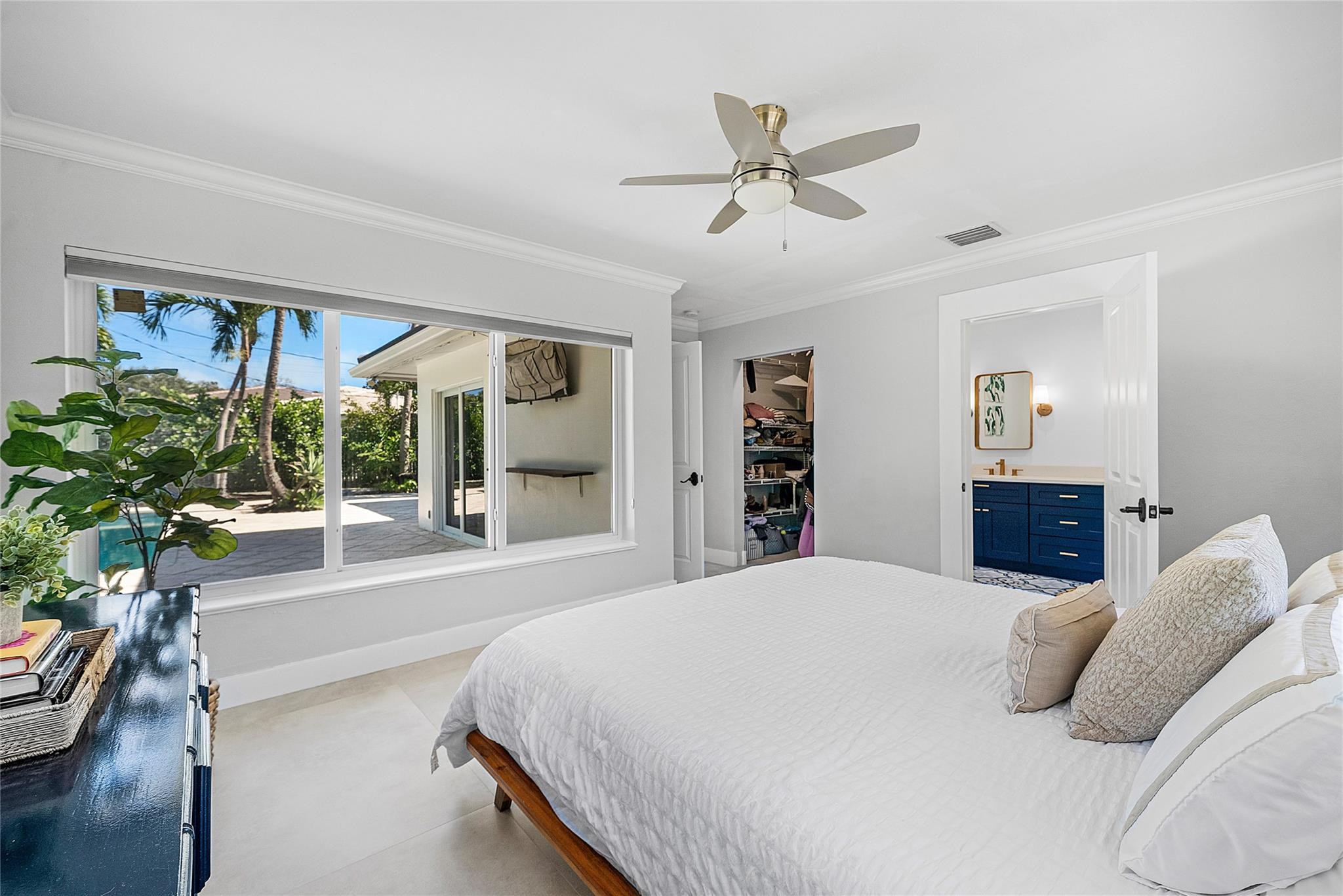 2233 Northeast 30th Court Lighthouse Point, FL 33064 - Photo 24 of 48 a bedroom with a large bed and a large window