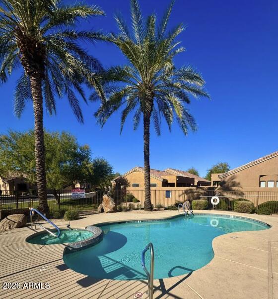 2565 South Signal Butte Road, Unit 23 Mesa, AZ 85209 - Photo 28 of 29 a view of a swimming pool with a table and chairs