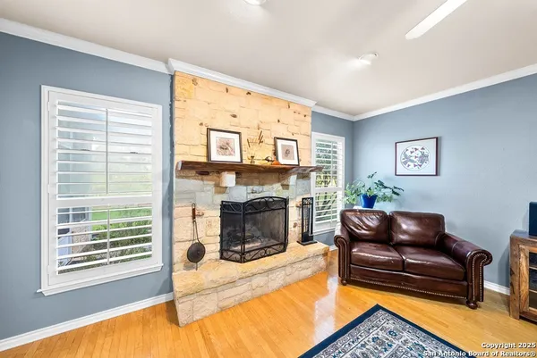 a living room with furniture flat screen tv and a fireplace