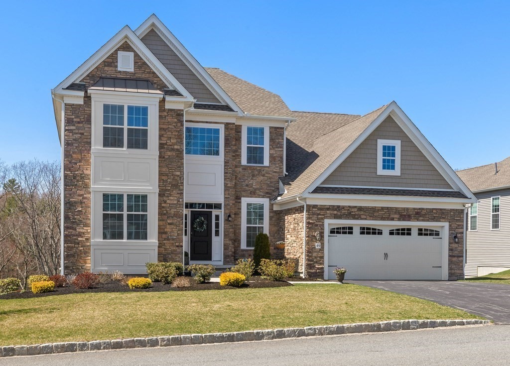 a front view of a house with a yard