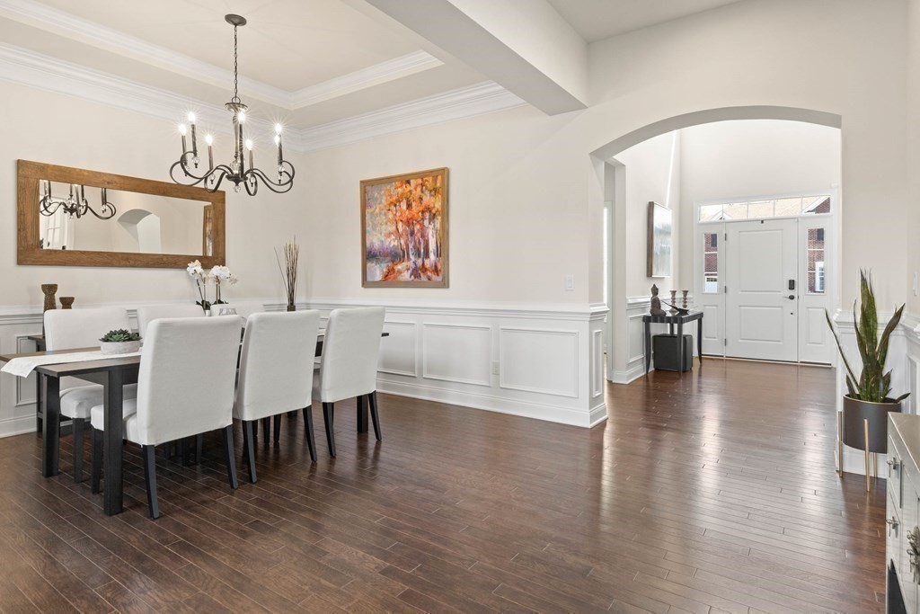49 Pine Tree Drive, Unit 49 Methuen, MA 01844 - Photo 14 of 38 a view of a dining room with furniture wooden floor and chandelier