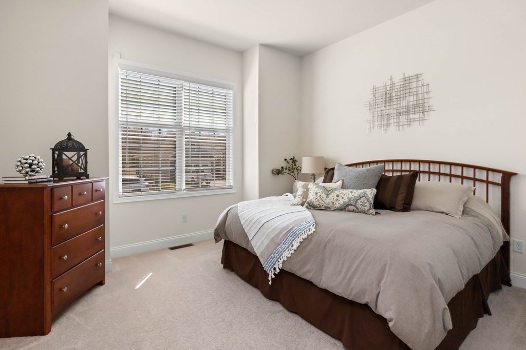 49 Pine Tree Drive, Unit 49 Methuen, MA 01844 - Photo 19 of 38 a bedroom with a bed and a window