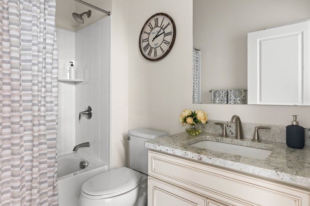 49 Pine Tree Drive, Unit 49 Methuen, MA 01844 - Photo 20 of 38 a bathroom with a toilet a sink and a mirror