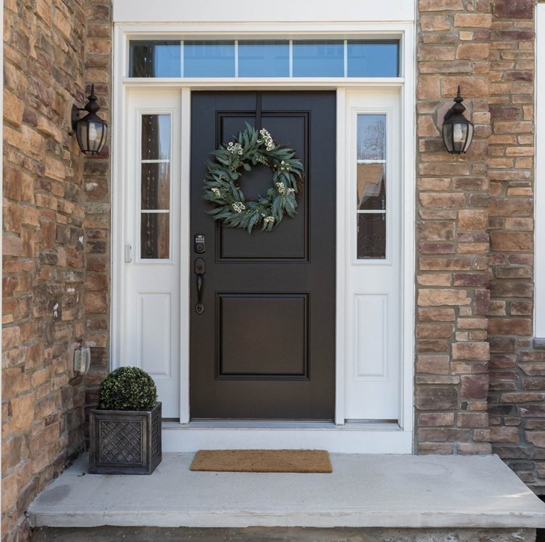 49 Pine Tree Drive, Unit 49 Methuen, MA 01844 - Photo 2 of 38 a front view of a house with potted plants