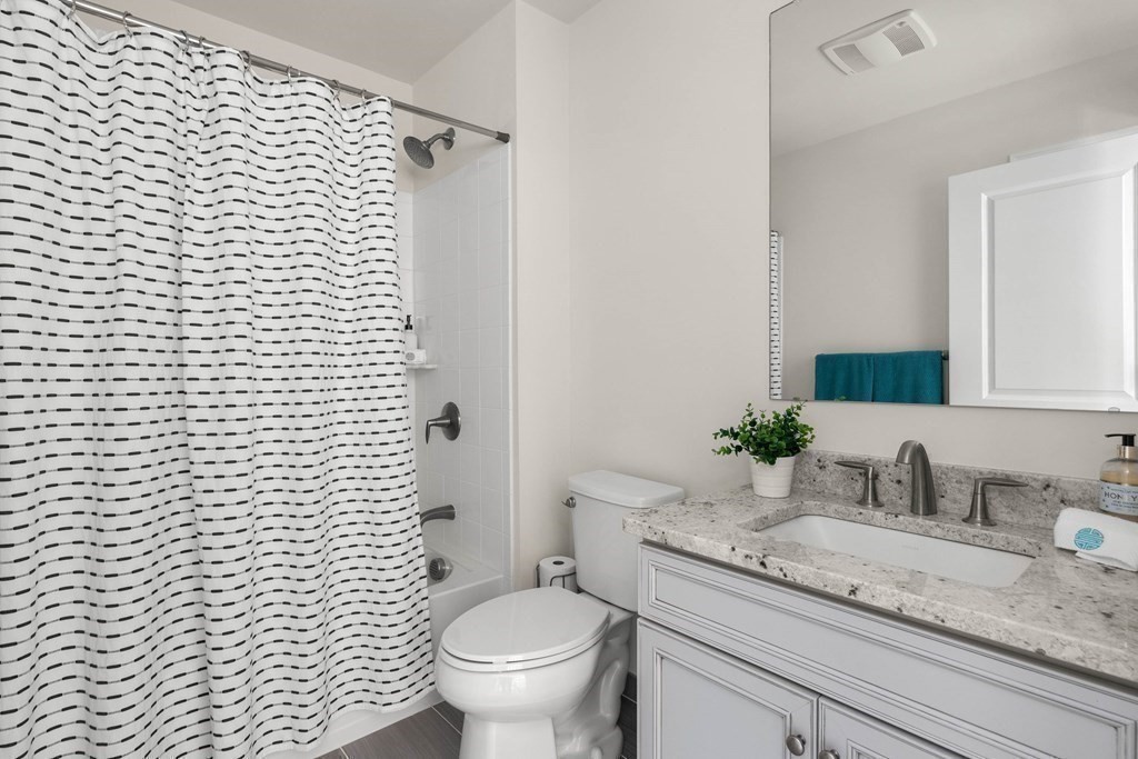 49 Pine Tree Drive, Unit 49 Methuen, MA 01844 - Photo 25 of 38 a bathroom with a granite countertop sink toilet and shower