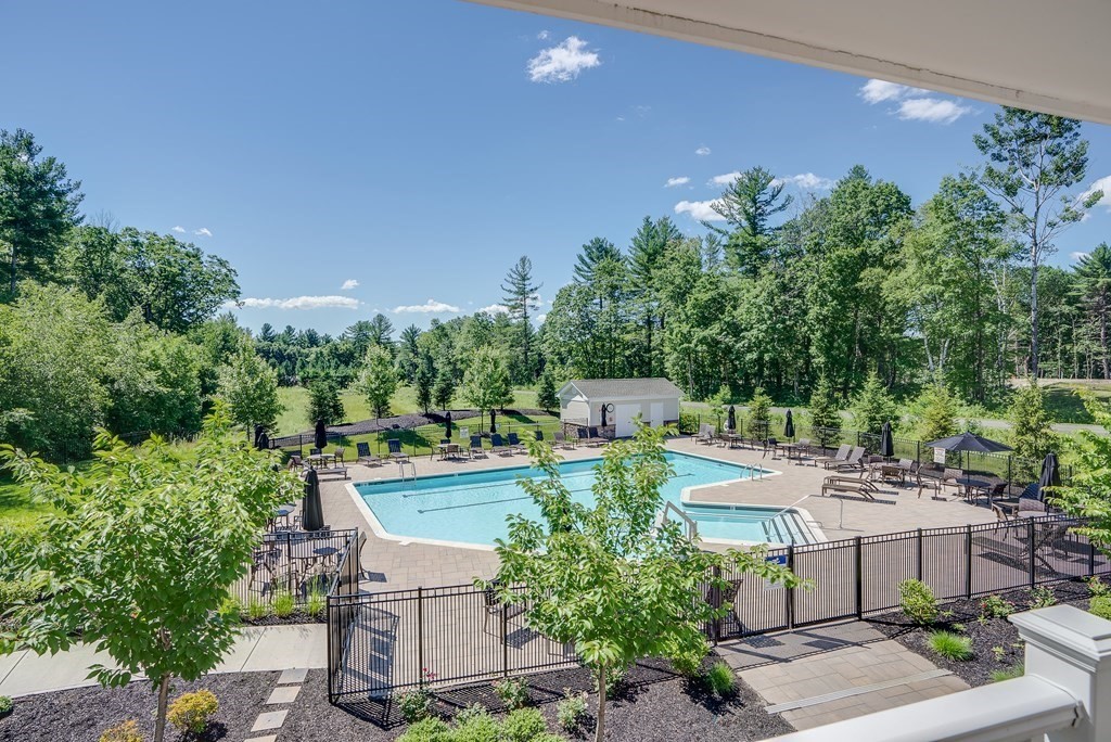 49 Pine Tree Drive, Unit 49 Methuen, MA 01844 - Photo 34 of 38 a view of a house with a patio and garden