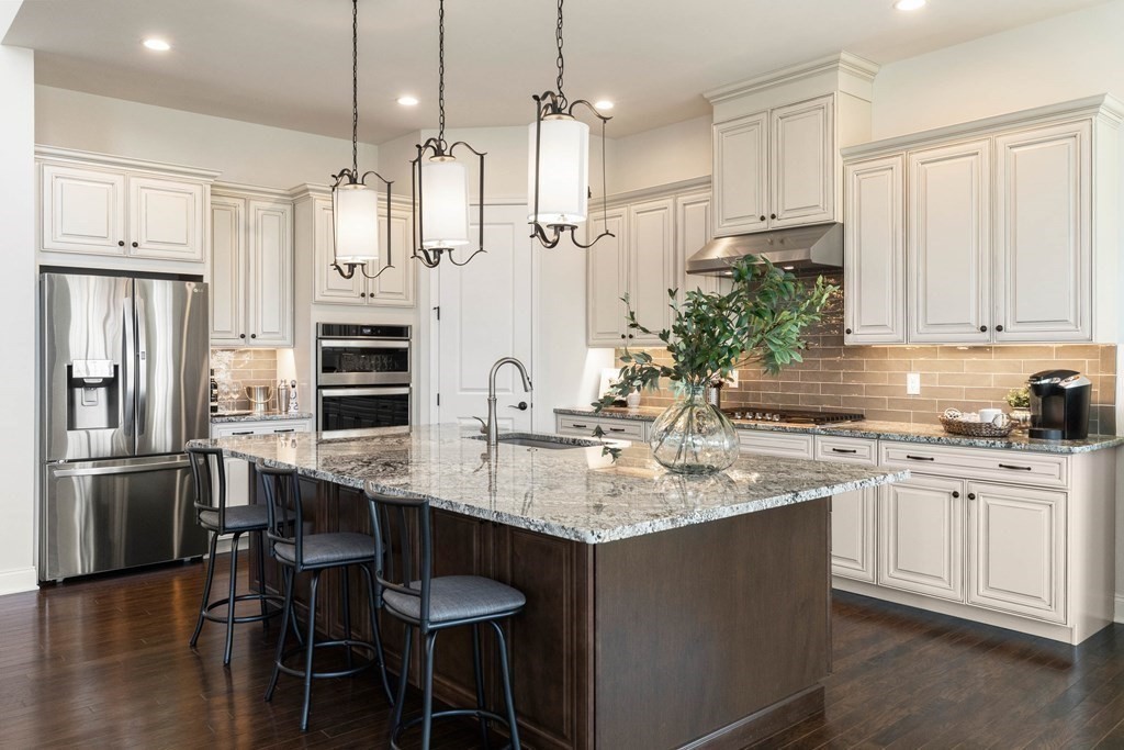 49 Pine Tree Drive, Unit 49 Methuen, MA 01844 - Photo 4 of 38 a kitchen with stainless steel appliances granite countertop a sink stove and refrigerator