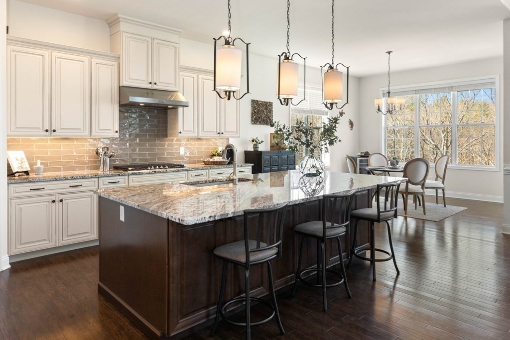 49 Pine Tree Drive, Unit 49 Methuen, MA 01844 - Photo 6 of 38 a kitchen with center island table and chairs
